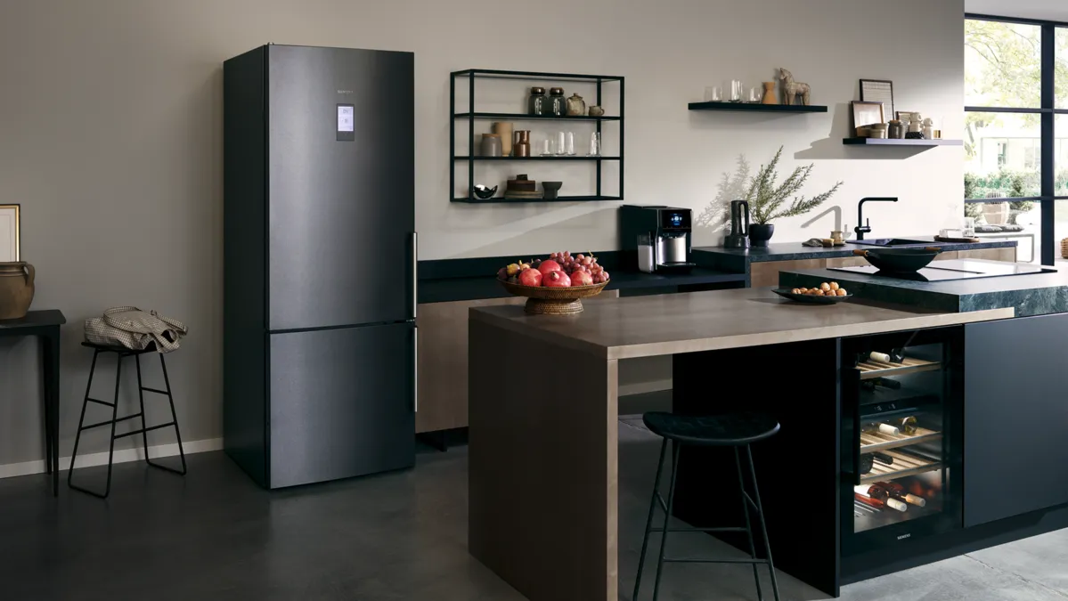 Siyah cihazlar, raflar ve ada karşı modern mutfak; minimalist dekor, doğal aydınlatma.