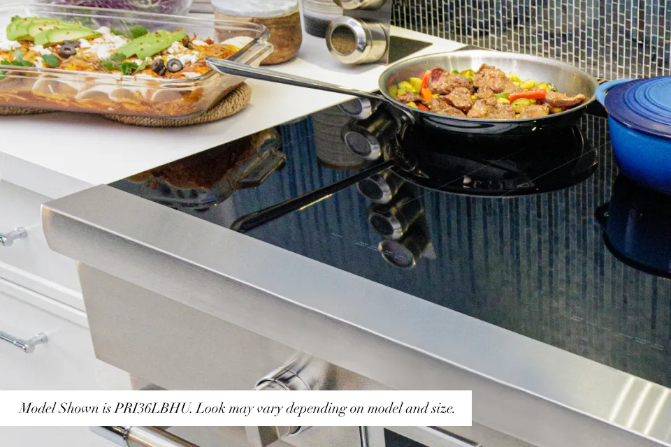 Frameless black glass cooktop covers the surface
