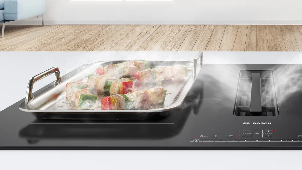 Vapour from the skewers cooking on a large tepannyaki pan is drawn into the integrated extractor in an induction hob.