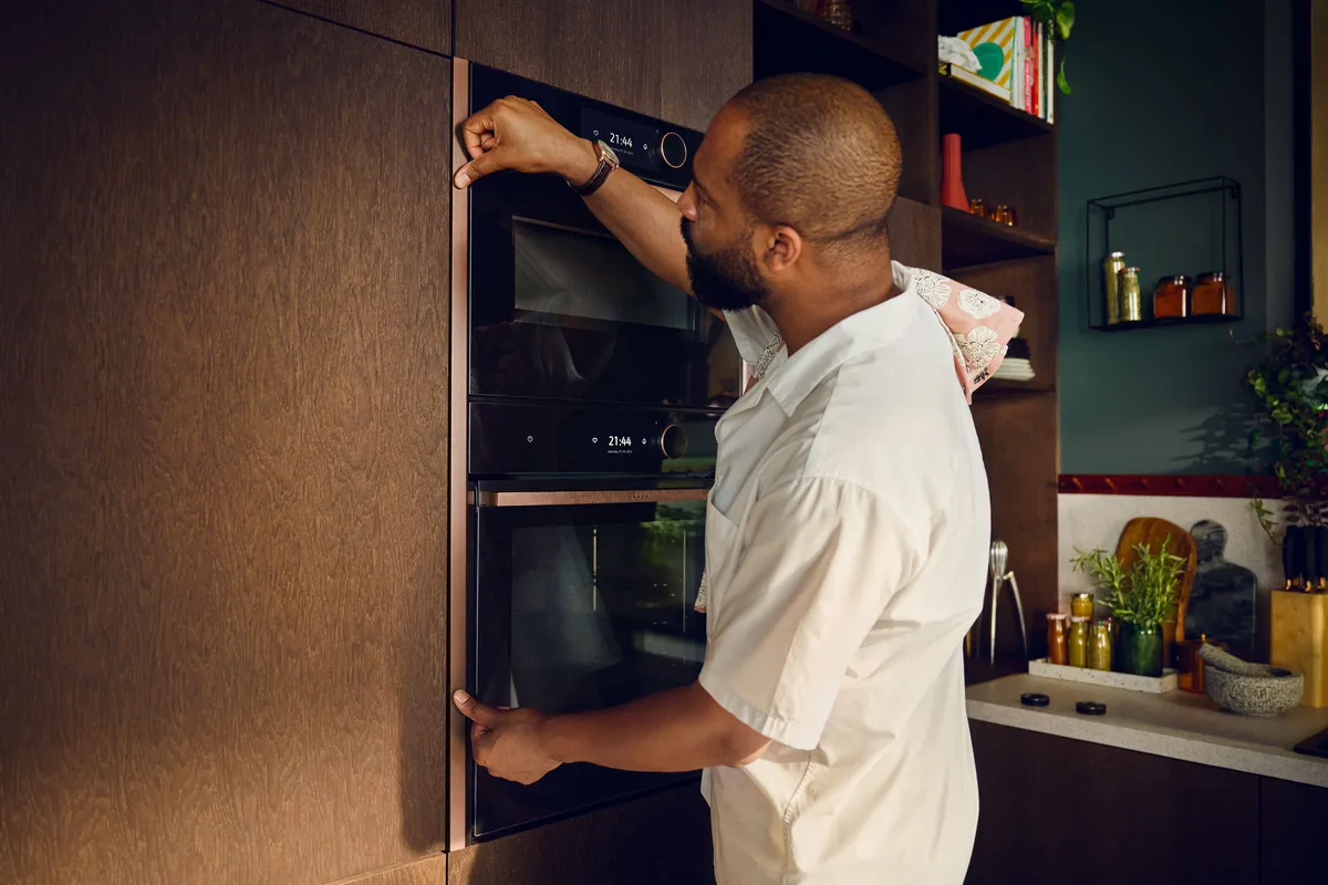A work surface in the kitchen full of cooking ingredients, pots and pans