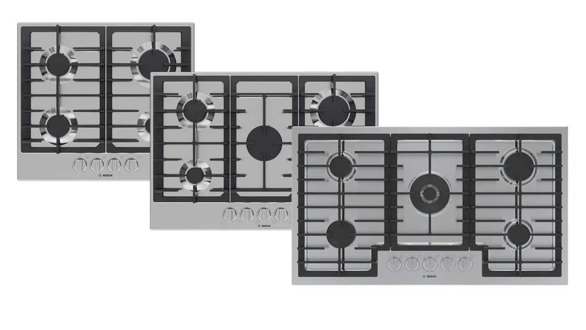 Three stainless steel gas cooktops of varying sizes, featuring multiple burners and grates, stacked in a slightly staggered arrangement.