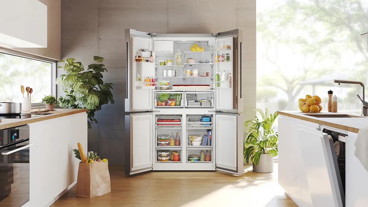 An inviting, modern kitchen full of Bosch appliances, including a big fridge-freezer with the doors open to reveal lots of food.