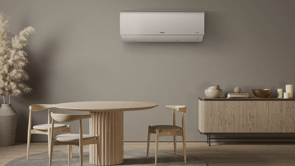 Ahşap masa, sandalyeler ve yanboard ile Minimalist yemek odası; duvardaki klima birimi.