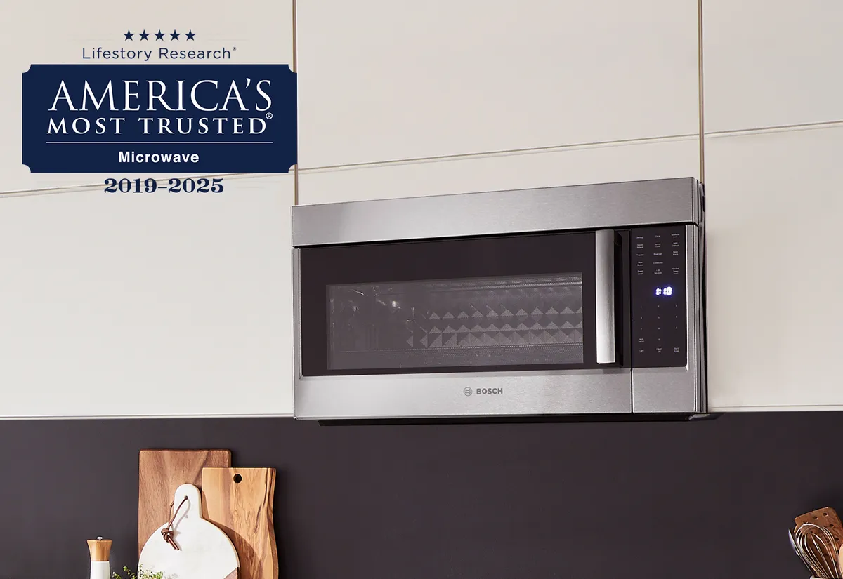 A sleek Bosch microwave mounted in a modern kitchen, featuring a "Most Trusted" award badge from 2019-2025.