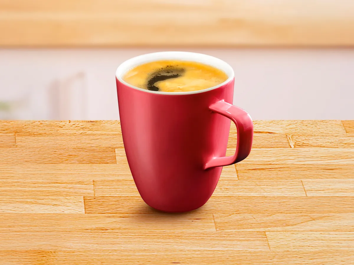 Red cup filled with americano coffee.