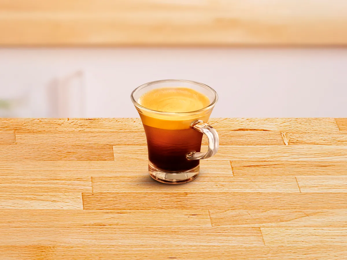 Small glass cup filled with espresso.