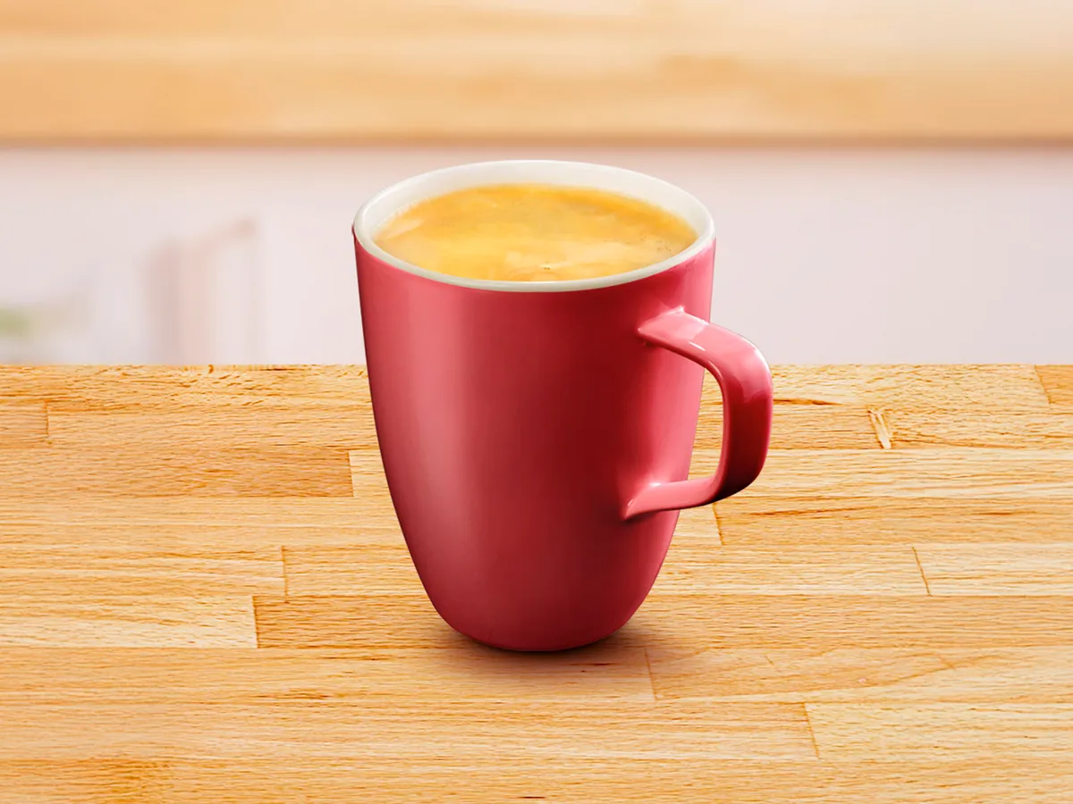 Red cup filled with Café Crema.
