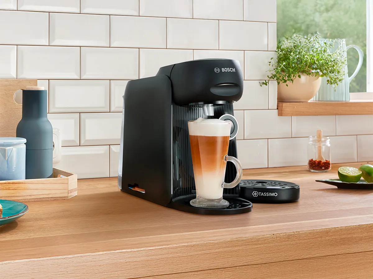 The coffee machine TASSIMO FINESSE friendly on a kitchen worktop.