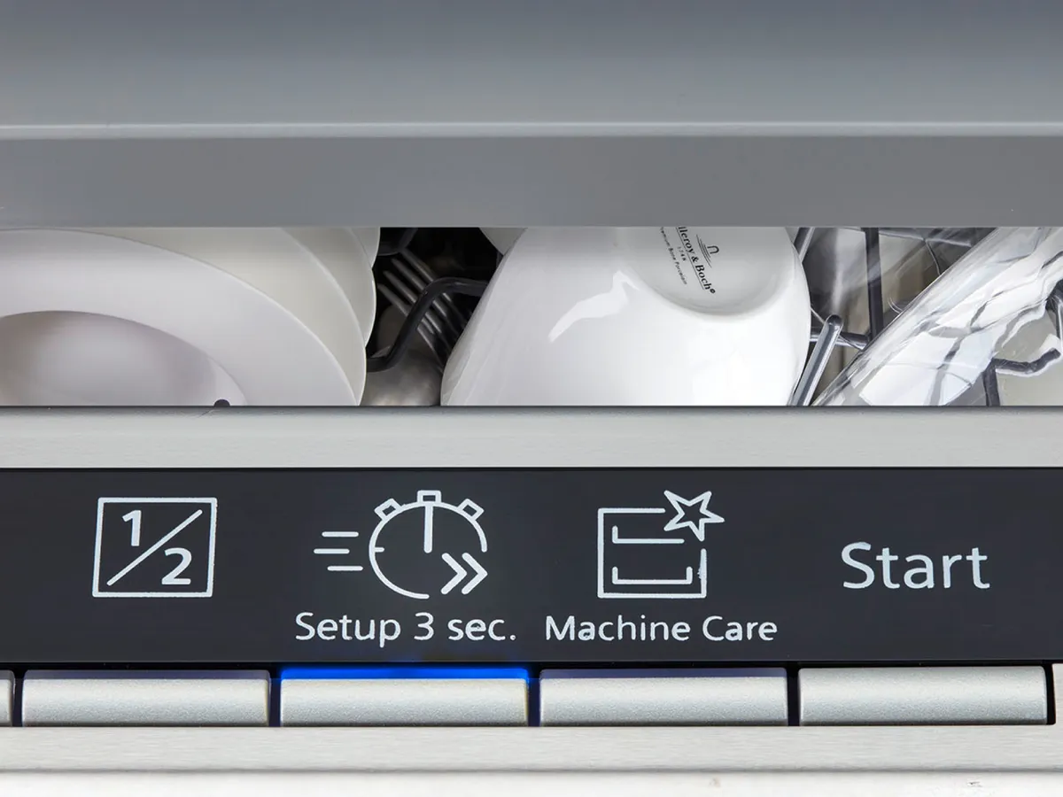 Open dishwasher with control panel showing cycle options and partially visible dishes inside.