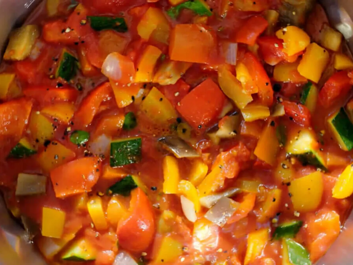 Top view of a cookit in which vegetables are being cooked.
