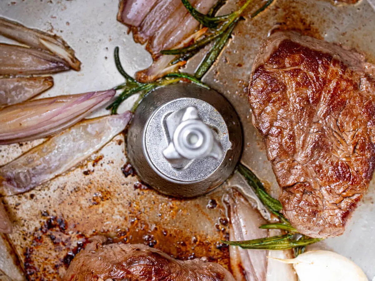 View from above into a cookit in which meat is fried.