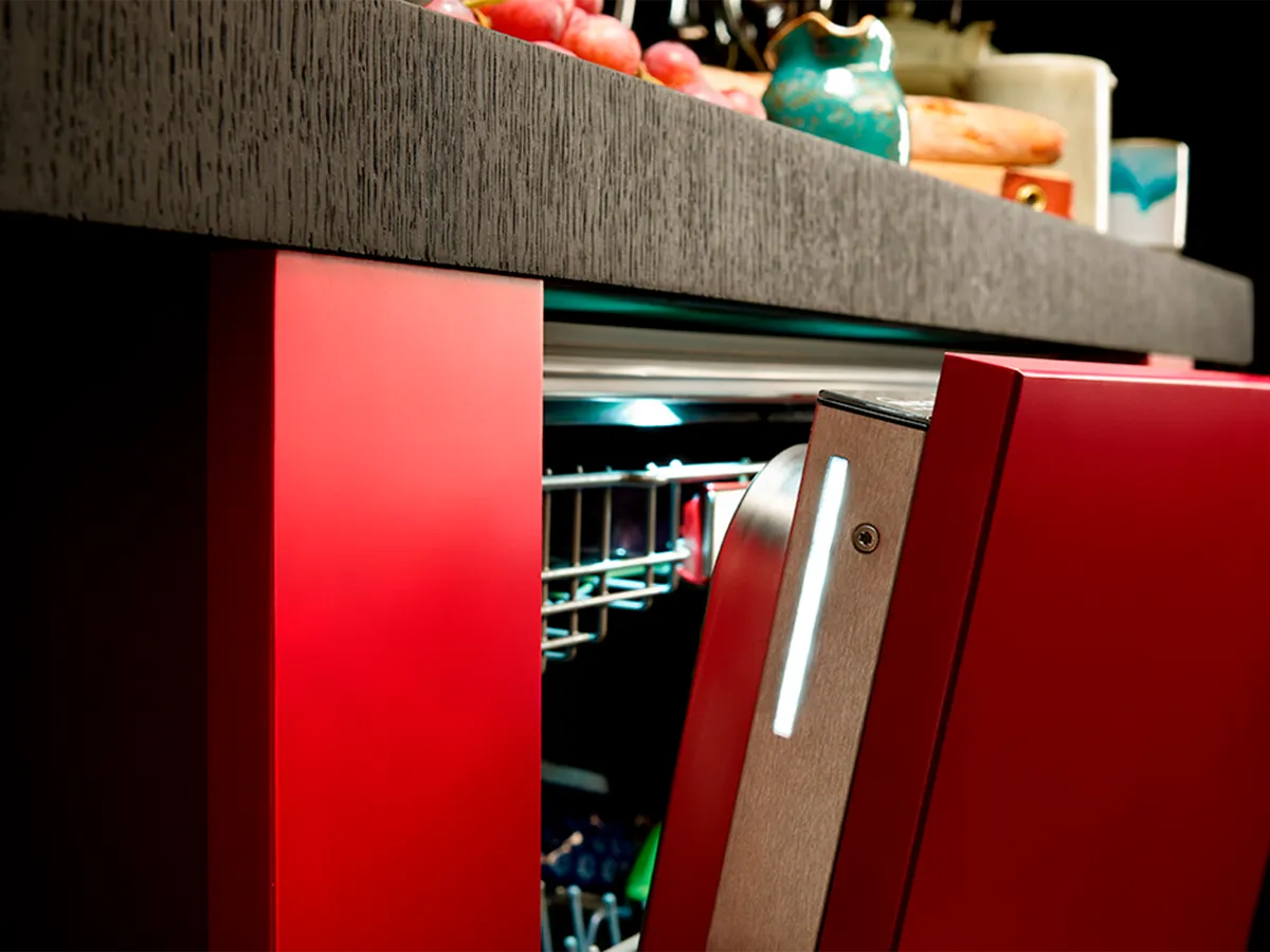 Hand opening a fully-integrated dishwasher with Door Open Assist feature.