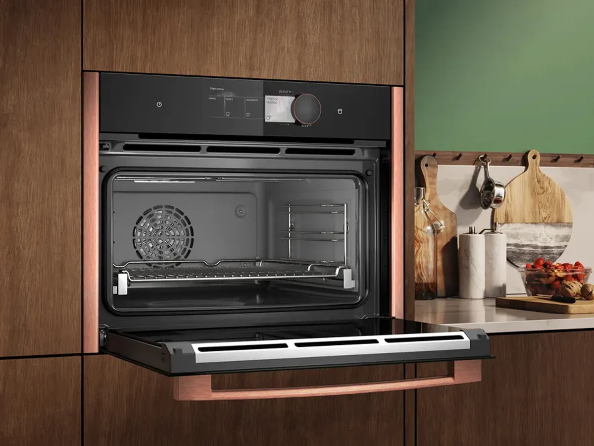 Microwave with Brushed Bronze side strips, shown with door open  