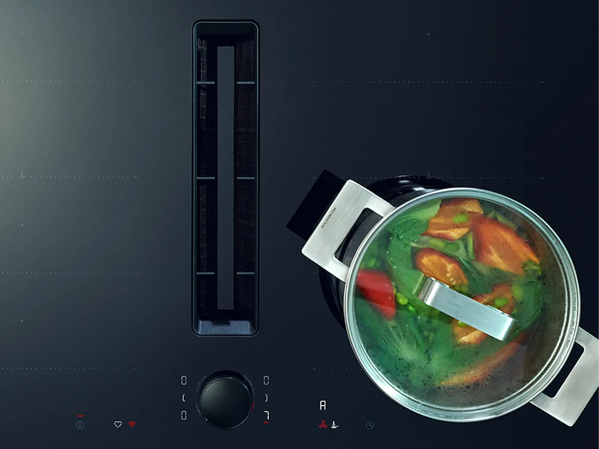 Aerial shot of induction cooktop with pans and garlic on the side  