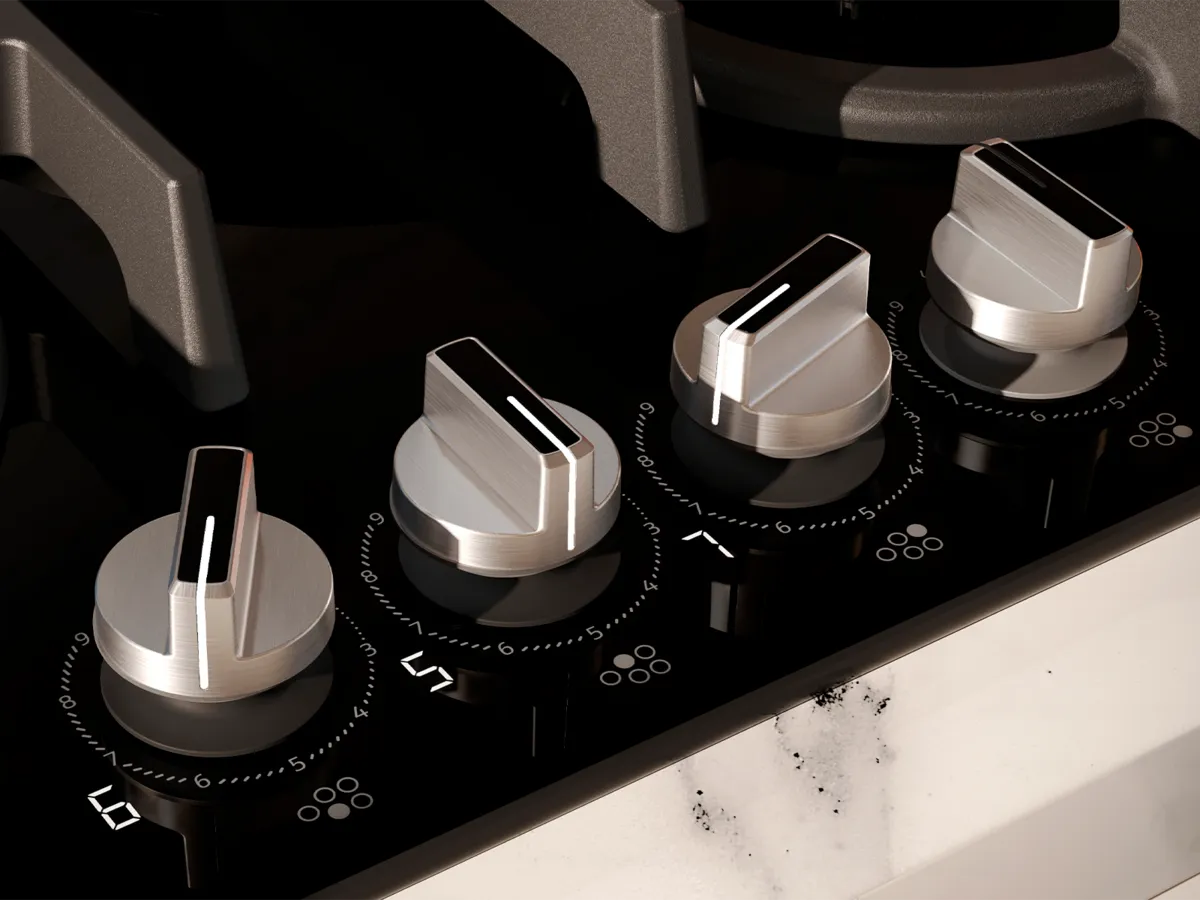 Detailaufnahme eines modernen Gas-Kochfeldes mit eleganten metallischen Knöpfen und einer brennenden Flamme.