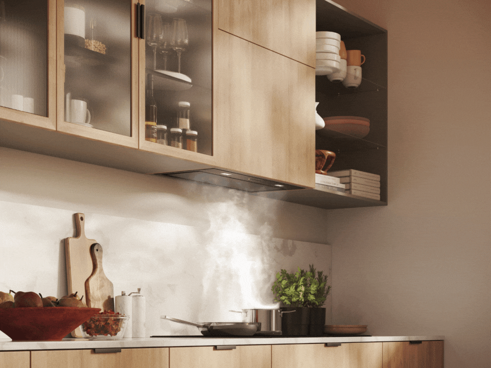 In a bright kitchen, a hood is perfectly integrated into the wooden furniture.