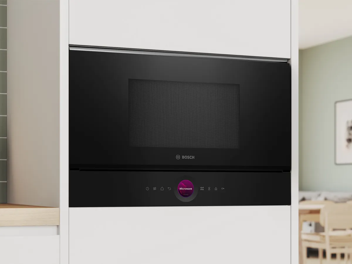 Micro-ondas embutido preto da Bosch com controle digital em um gabinete de cozinha moderno.