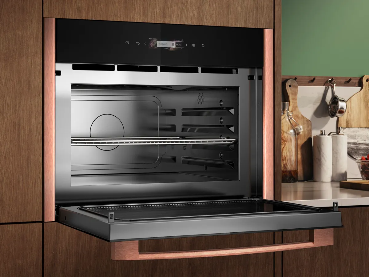 A built-in NEFF microwave integrated in a brown kitchen