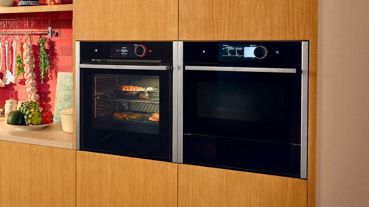 A modern kitchen featuring two ovens and a microwave, showcasing a functional cooking space.  