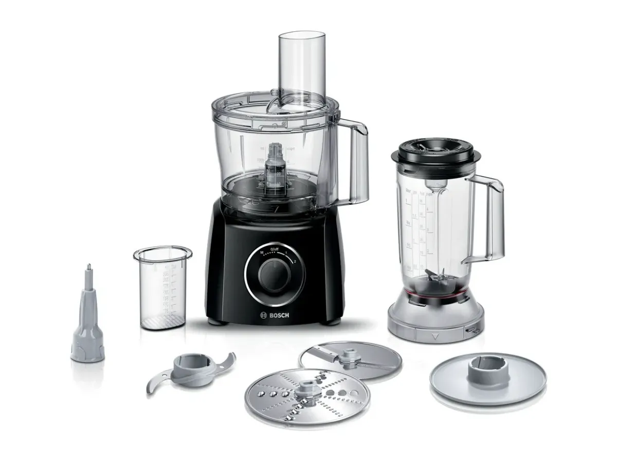 A Bosch food processor set displayed on a black background, featuring a black food processor with a clear bowl, a blender with a measuring jug, and various attachments including slicing discs and a pouring spout, all arranged for versatility in food preparation.