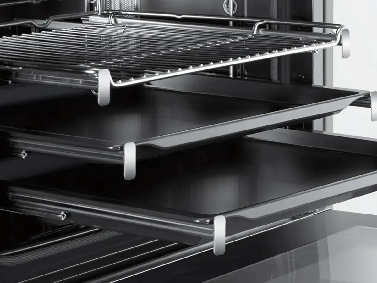 An open black oven showcasing a chrome wire rack and a sleek.