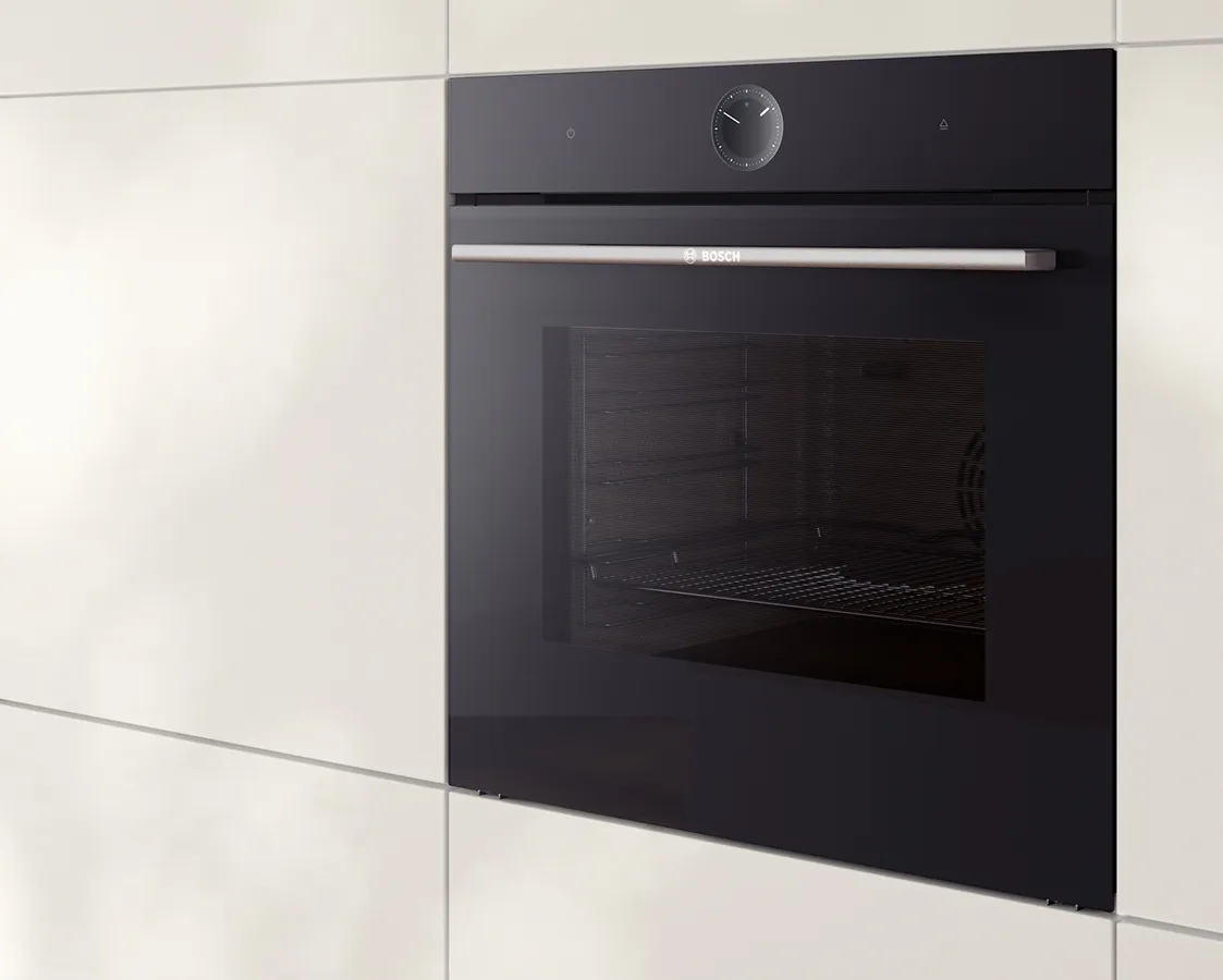 Modern black oven built into a sleek kitchen cabinet, with an icon of directional signs in the top left corner. 