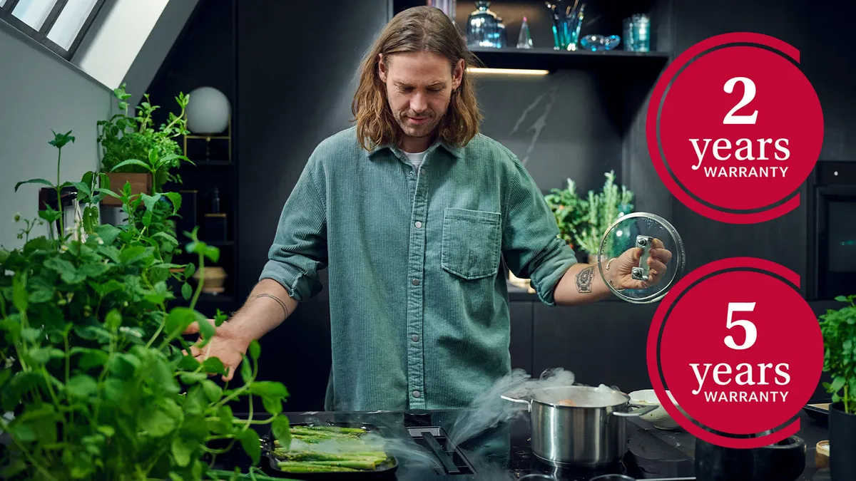 In a kitchen, a man and woman collaborate to prepare food, surrounded by various cooking tools and ingredients.