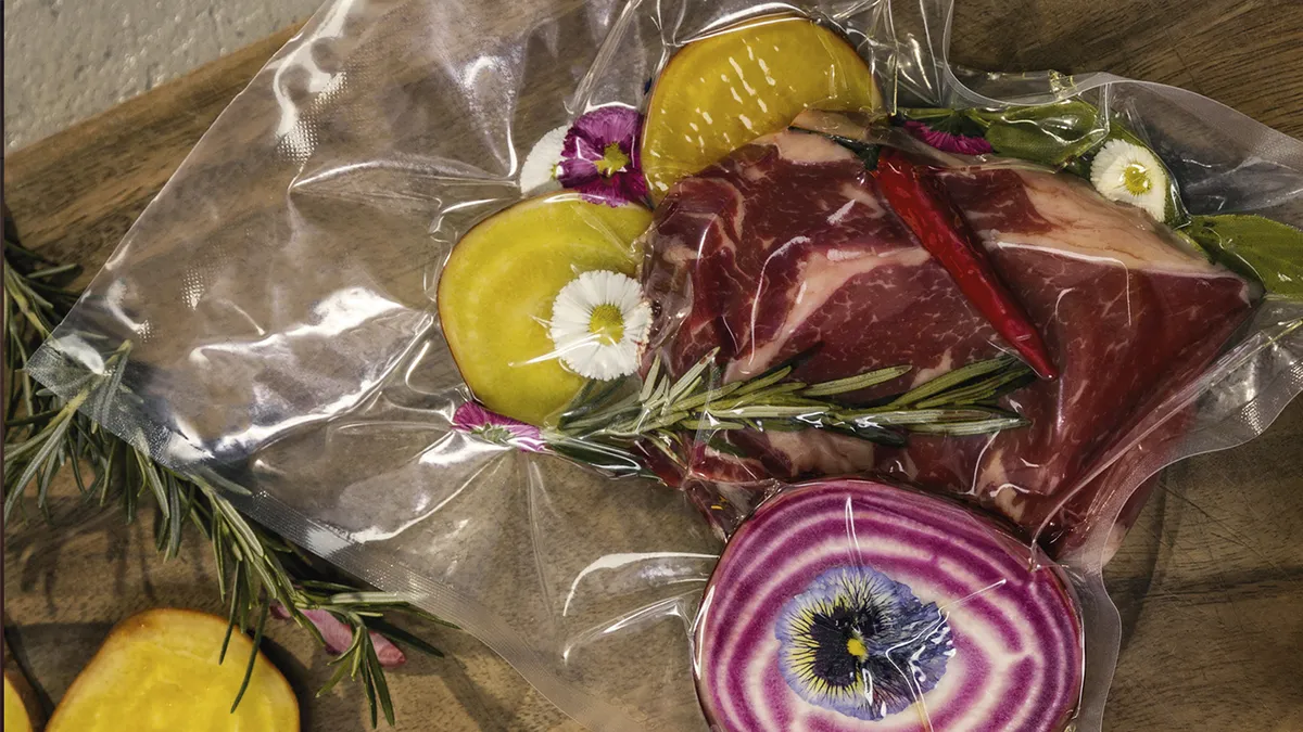 Assorted meat and vegetables neatly packaged in clear plastic bags for storage or sale.  