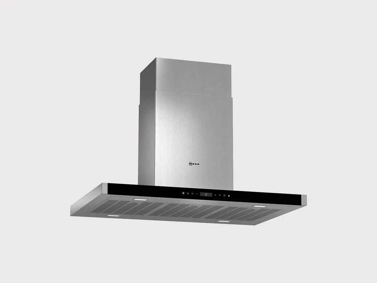 Stainless steel kitchen hood with a sleek design, featuring a glass panel and touch controls, mounted above a cooking space.