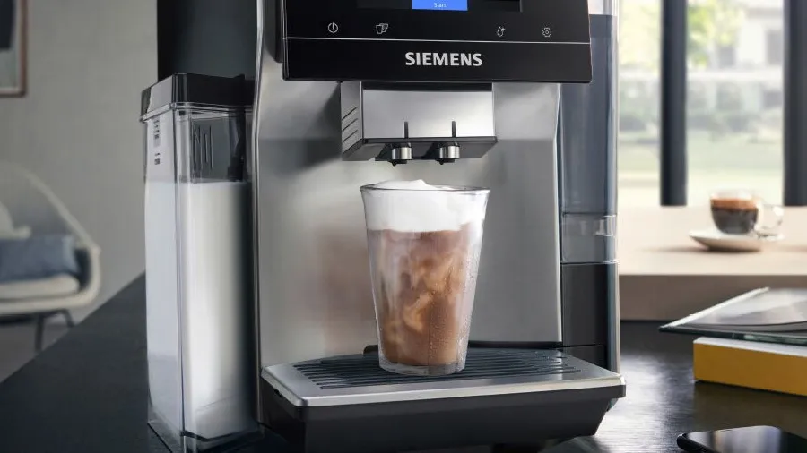 Siemens coffee machine with mug underneath with steamed milk