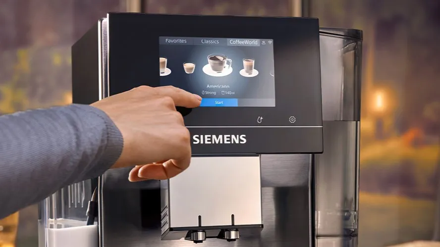 Person using touchscreen display on Siemens coffee machine
