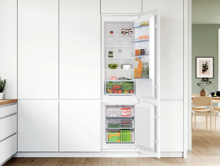 Opened free standing fridge freezer