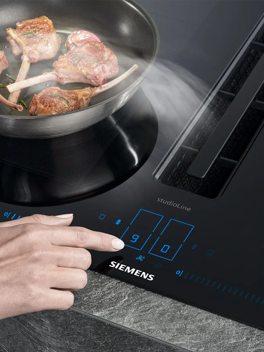 inductionAir Plus hob with different foods being prepared in a casserole