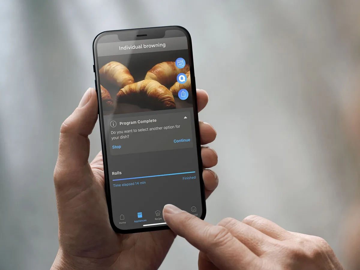 Person using a phone and the home connect app