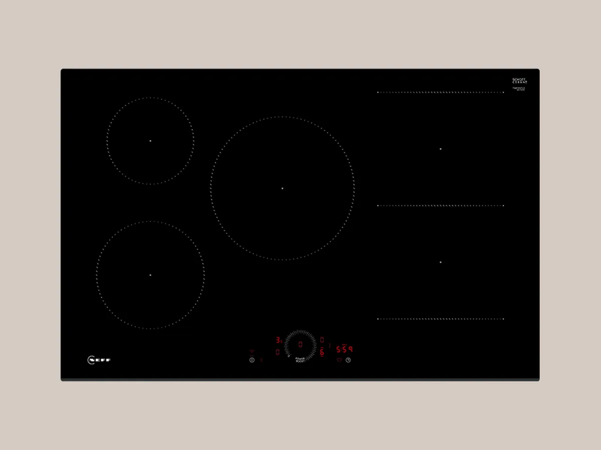 A sleek black induction cooktop featuring three cooking zones and a central control knob for precise heat settings.