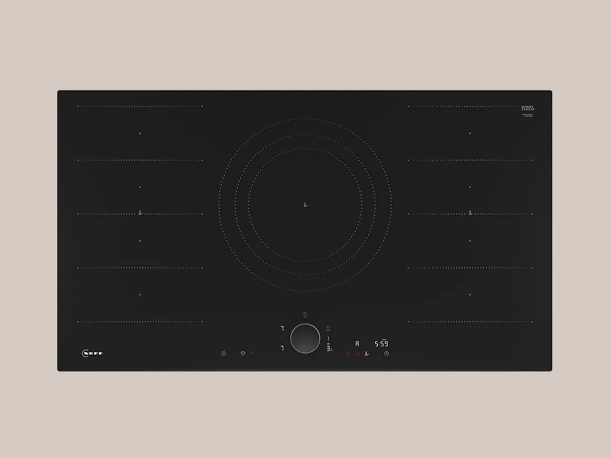A sleek black induction cooktop featuring five cooking zones, touch controls, and modern design for efficient cooking.