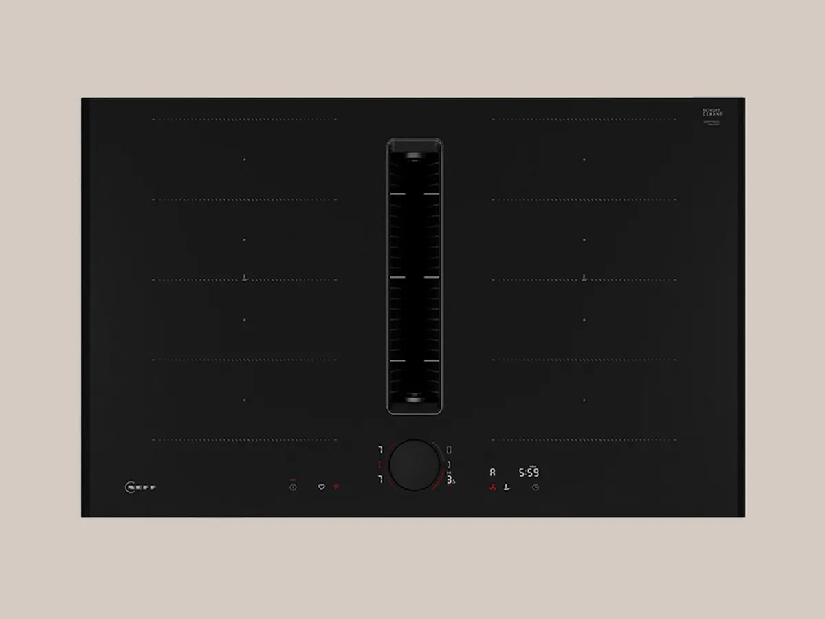 A black stovetop with three red heating elements glowing, while one burner remains off. Modern design with touch controls visible.