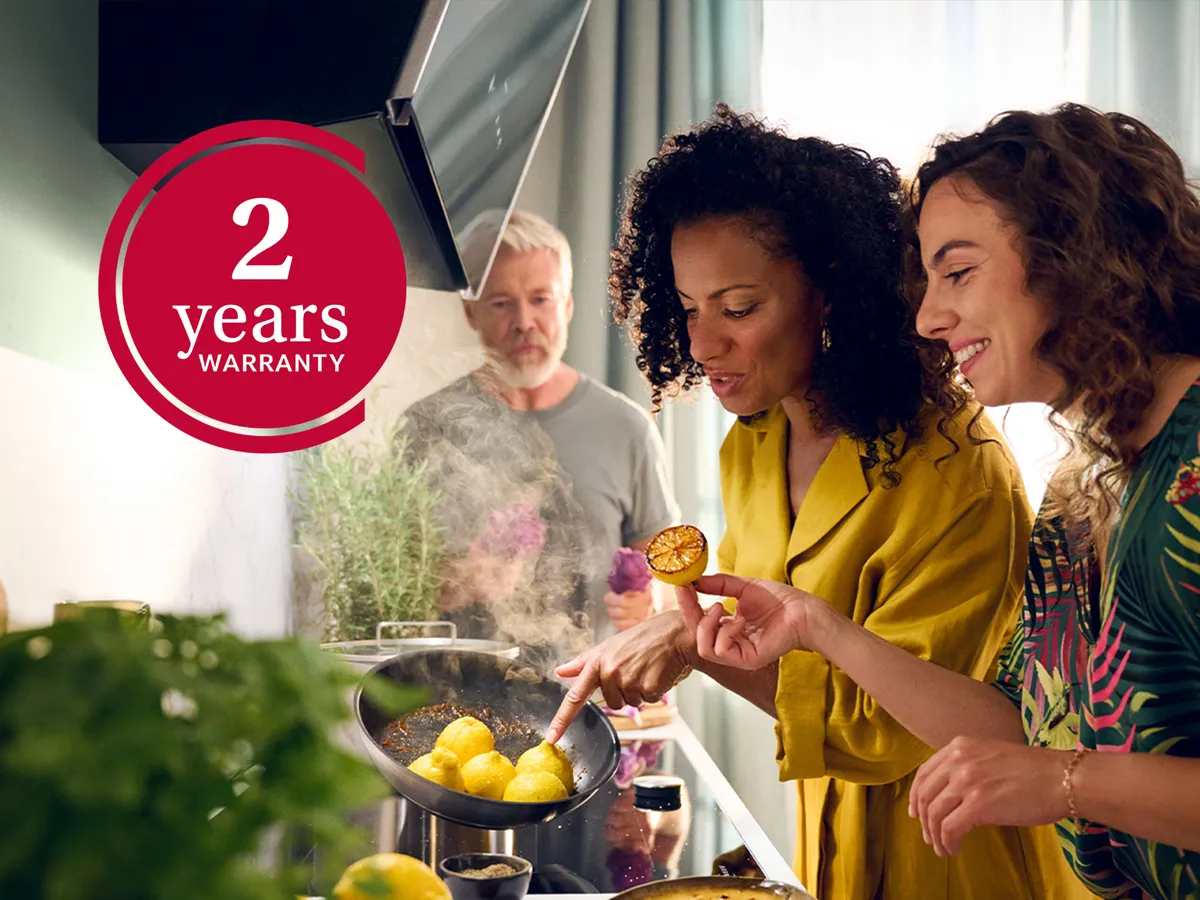 A man and woman are engaged in food preparation in a kitchen, working together with fresh ingredients and utensils.