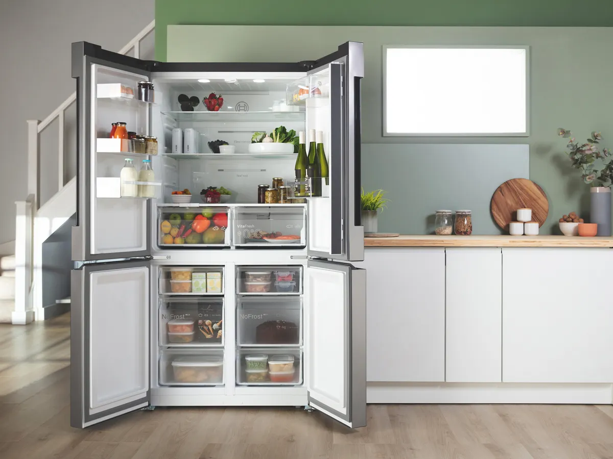Open fridge freezer in sage green kitchen