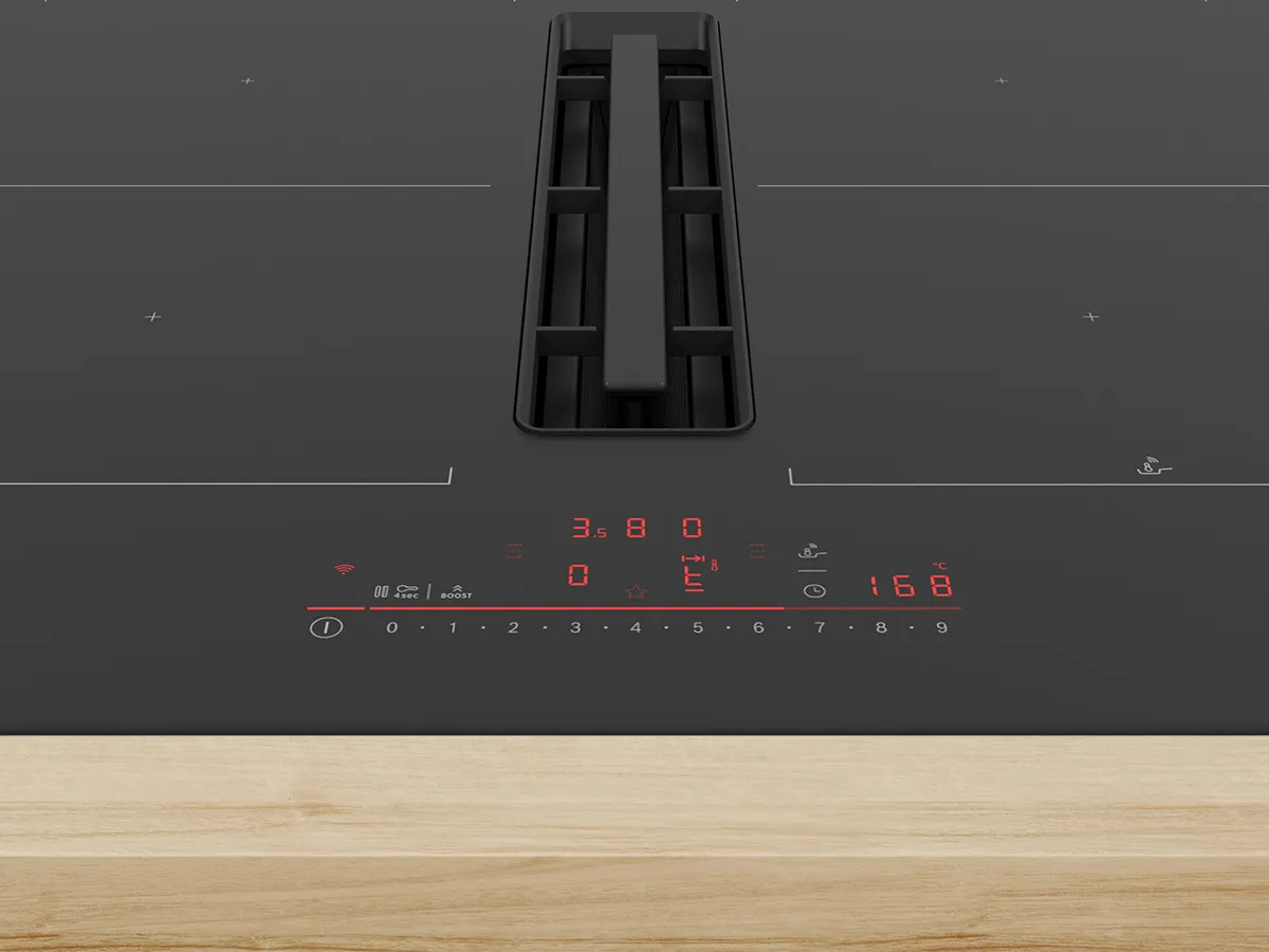 Modern kitchen with a ceiling-mounted stainless steel range hood above a wooden island.