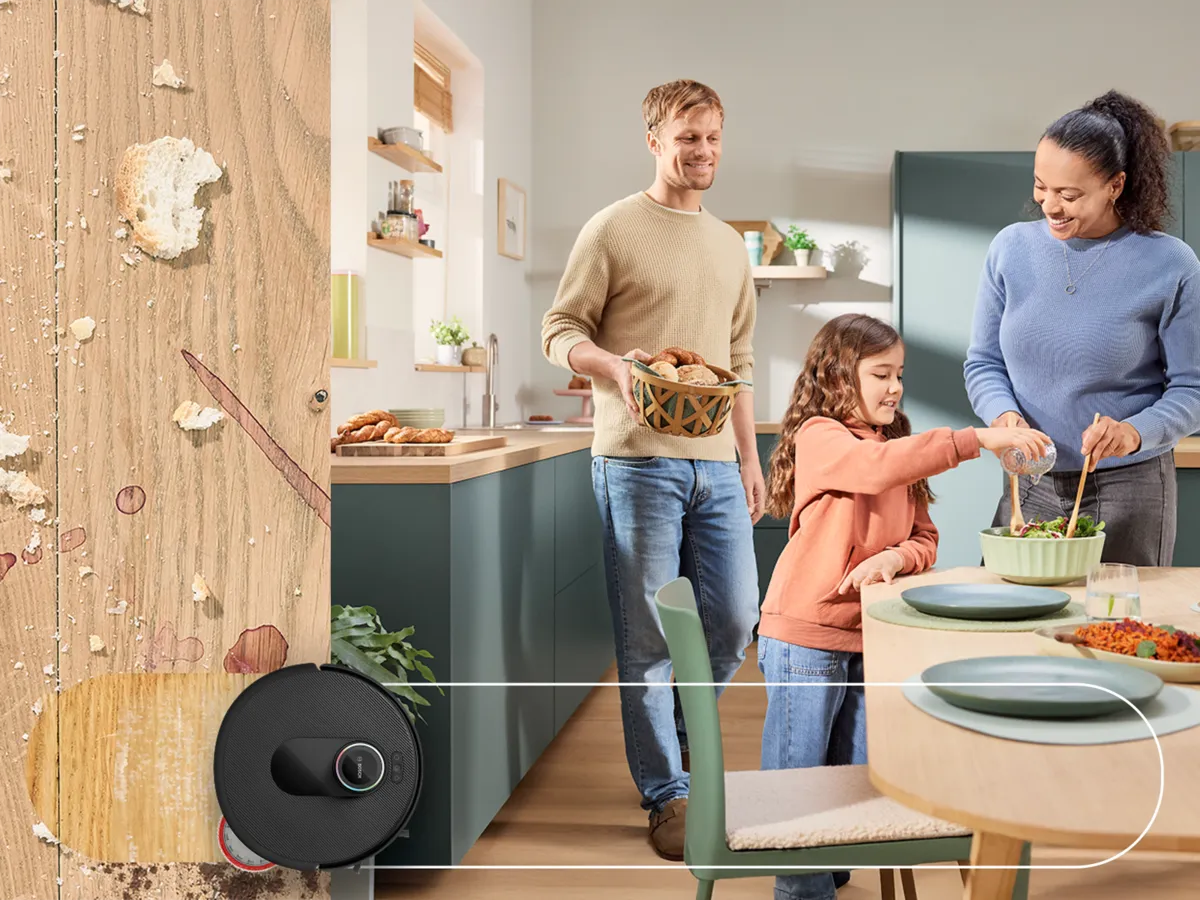 A family cooks together in a modern, clean kitchen filled with fresh ingredients and kitchenware.