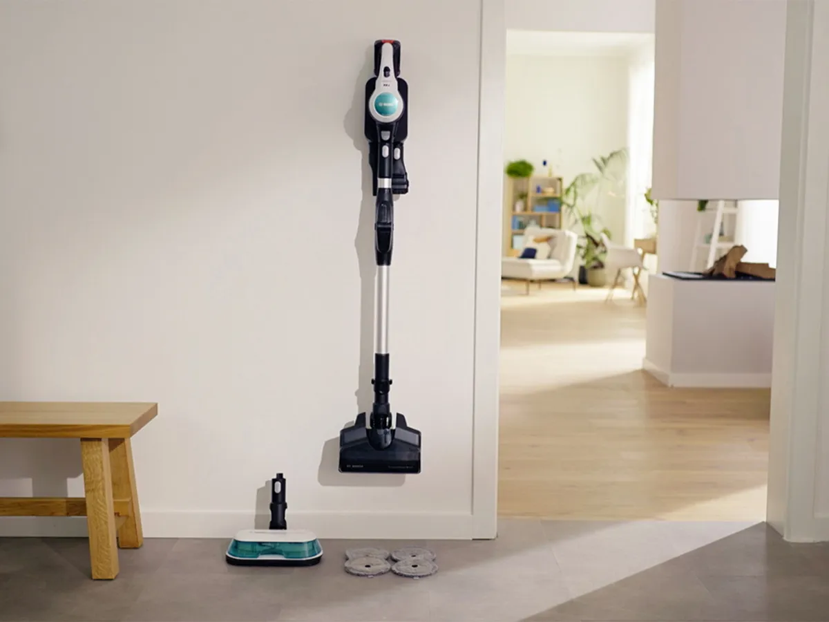 Unlimited 7 hanging on wall showing regular vacuum head as well as mop head