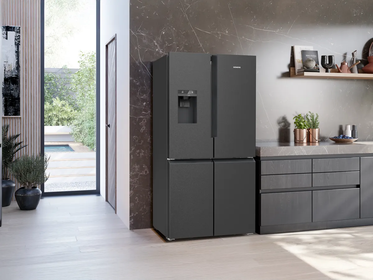 Siemens black refrigerator with a water dispenser in a modern kitchen setting.