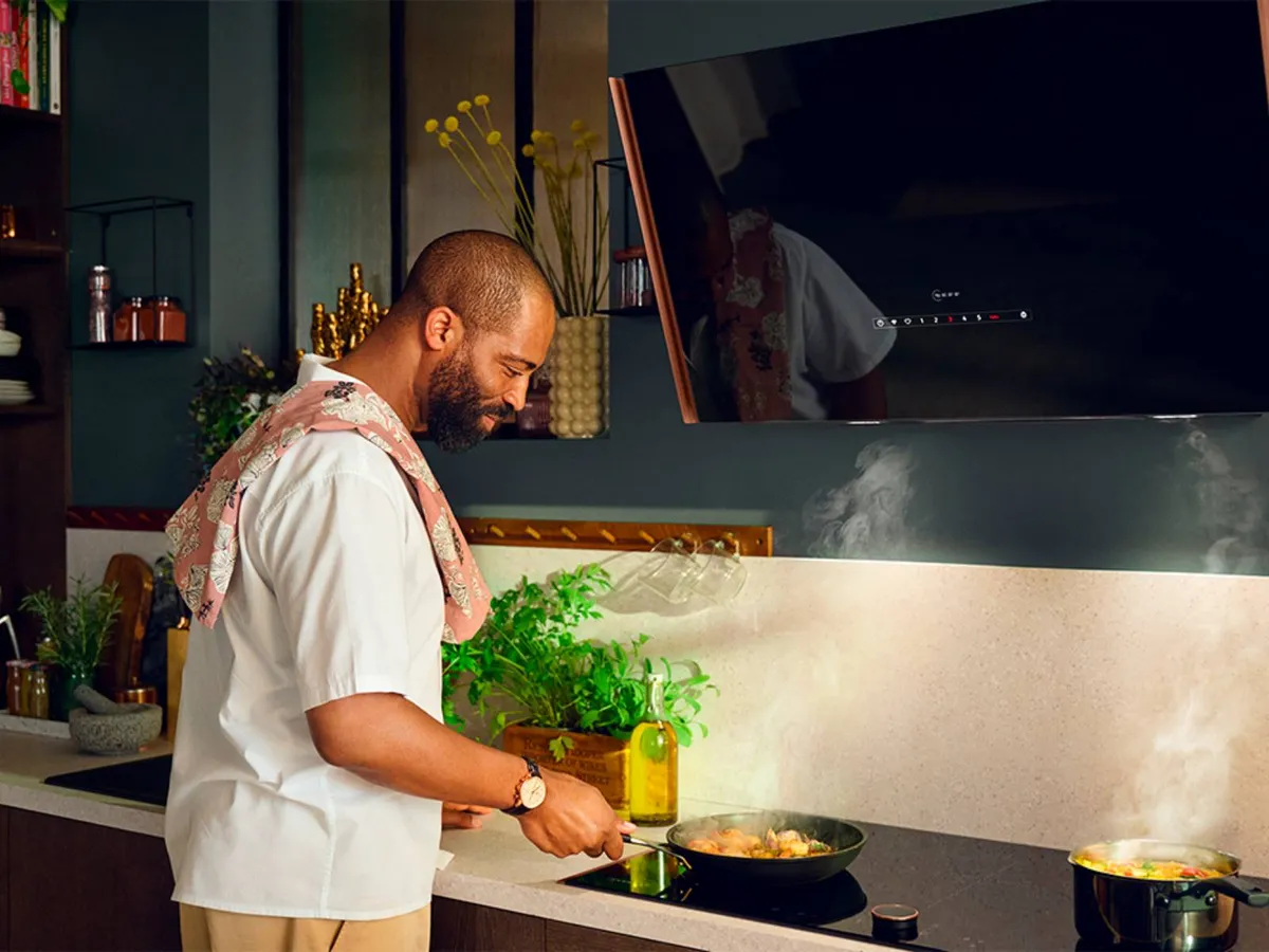 Man cooking over a pan on a Neff hob