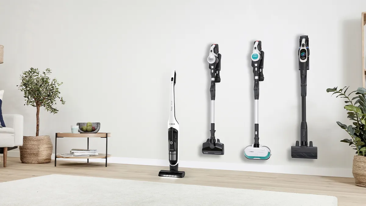 Lineup of four Bosch cordless vacuum cleaners in a bright modern living room.