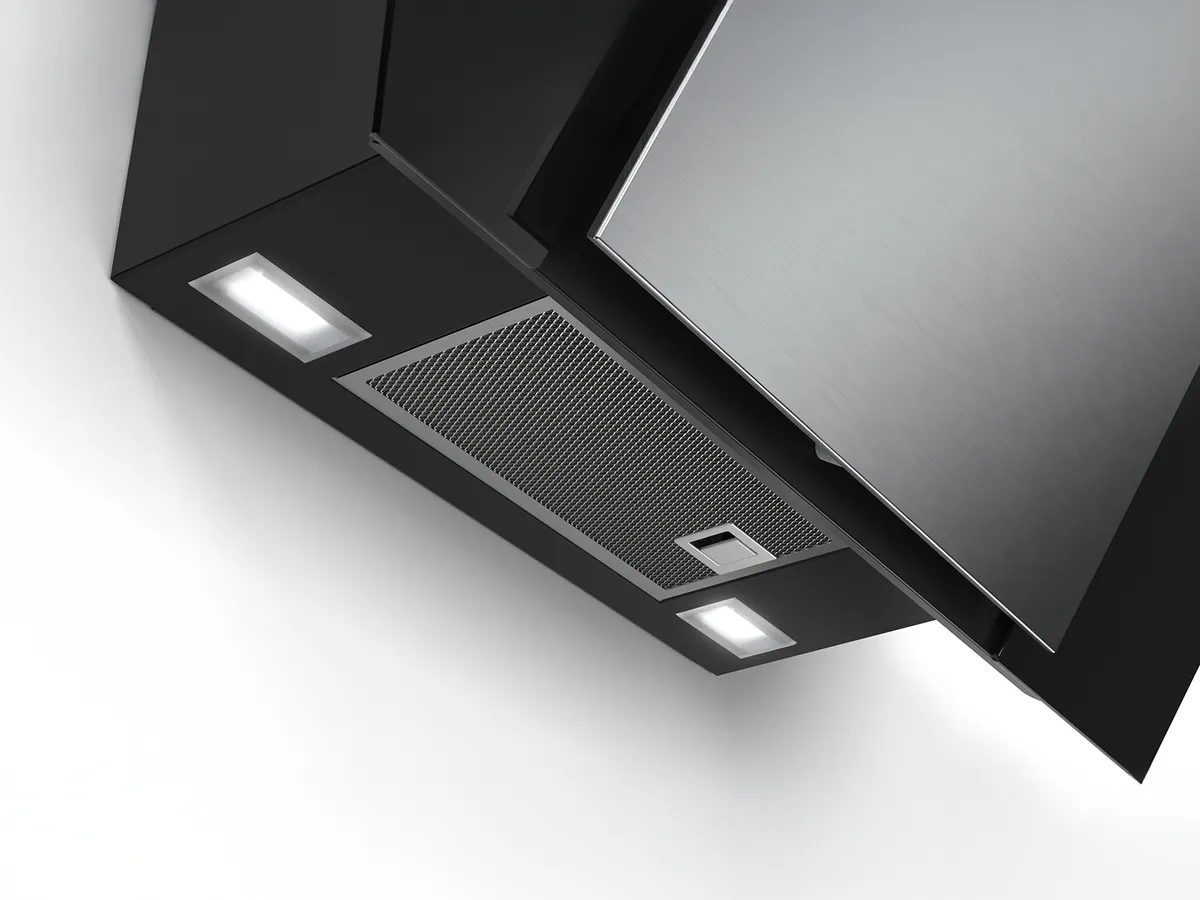 A sleek black range hood with a stainless steel finish, featuring built-in lights and a metallic mesh filter, mounted on a white wall.