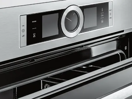 An open modern Bosch oven with a digital display showing a steam cooking function.