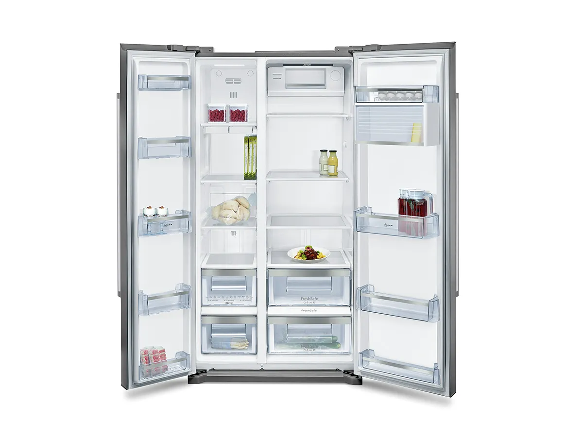 Open refrigerator with various food items and shelves visible.