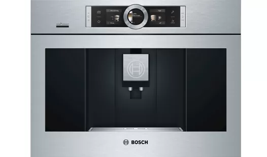 A sleek silver Bosch coffee machine with a digital display and coffee brew area, showcasing a modern kitchen appliance design.
