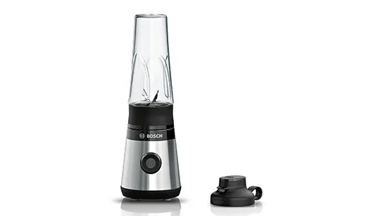 Sleek, compact blender with glass container and black base, designed for smoothie preparation.